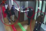 A CCTV screenshot of men with red circles around them