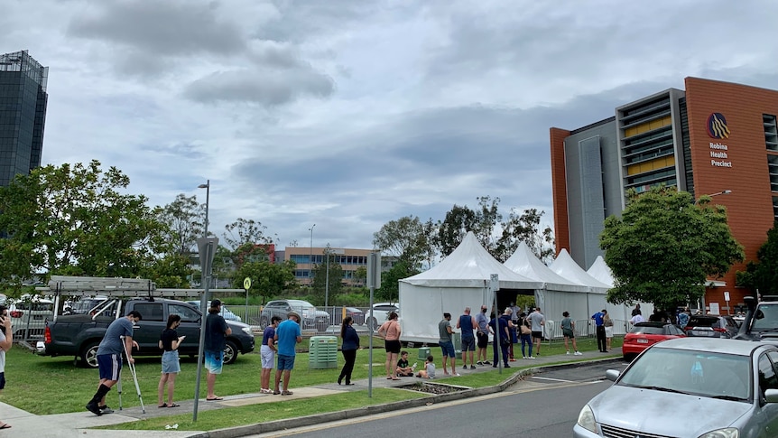 People lining up outside a pop-up COVID testing clinic