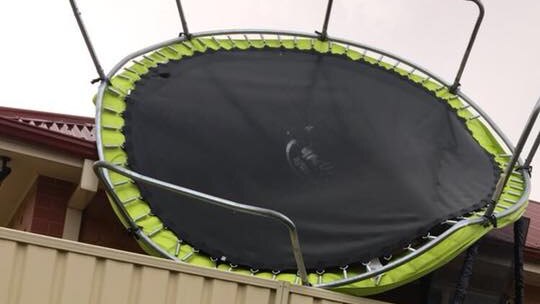 A trampoline is blown onto a house in Mildura after a severe storm.