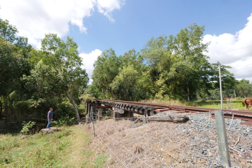 a railway track running over a small creek