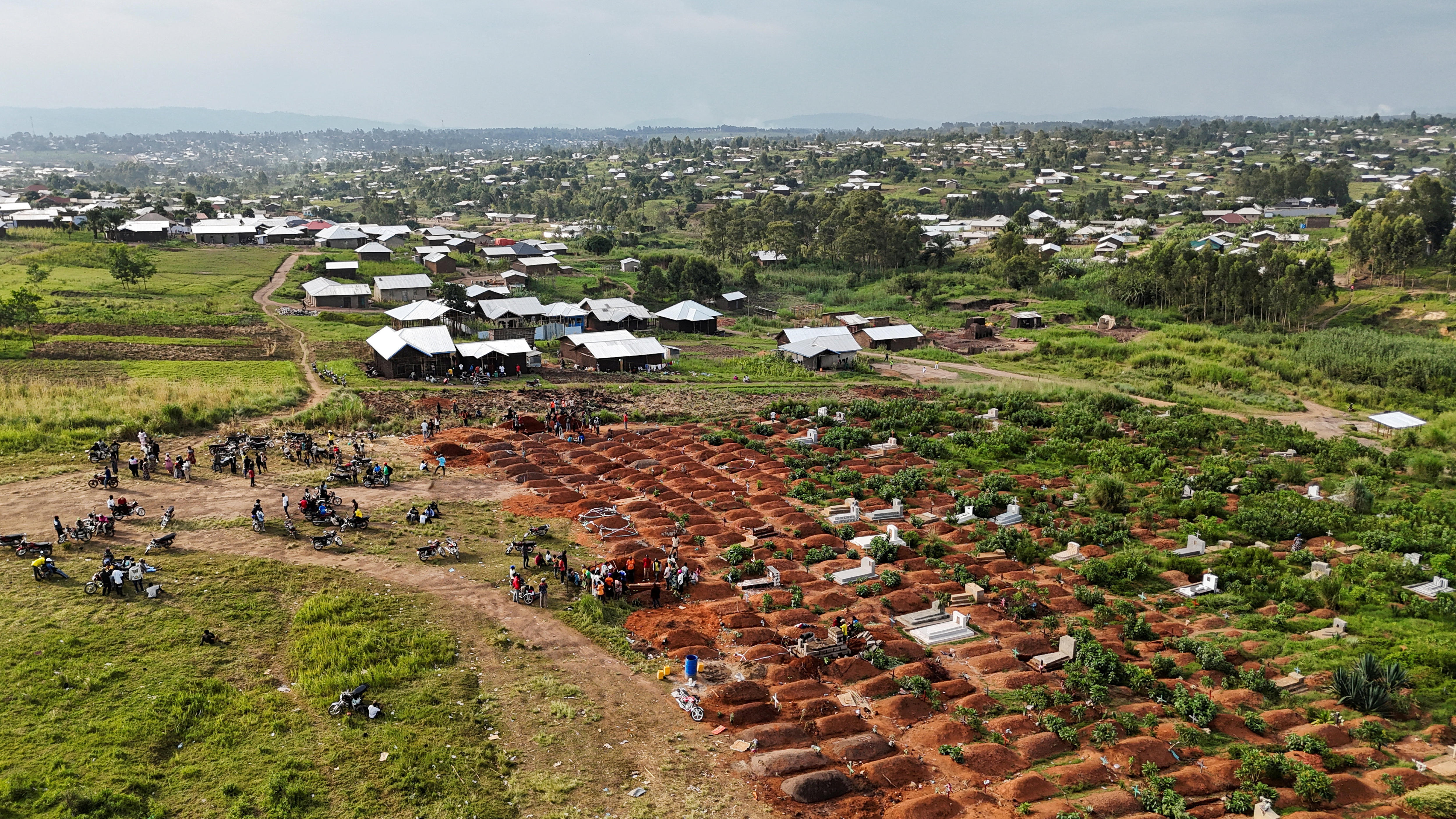 A drone view of displaced people from the Kigonze camp attending the burial of suspected Ebola victims.
