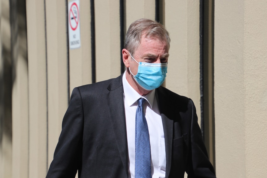Headshot of a man in a face mask in sunshine