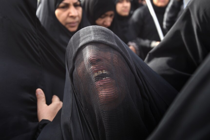 Family members grieve during the funeral procession of anti-government protester Abdul Ridha Mohammed in Malkiya, Bahrain