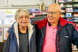 An older couple in a grocery store
