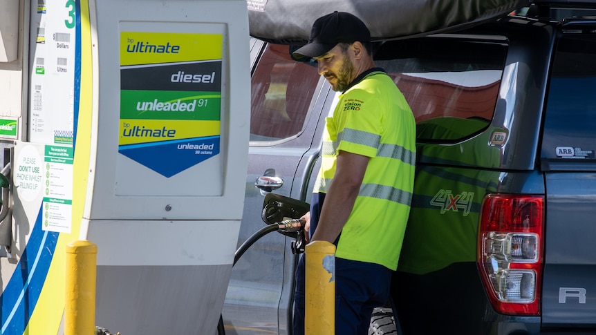 A man fills his car with petrol.