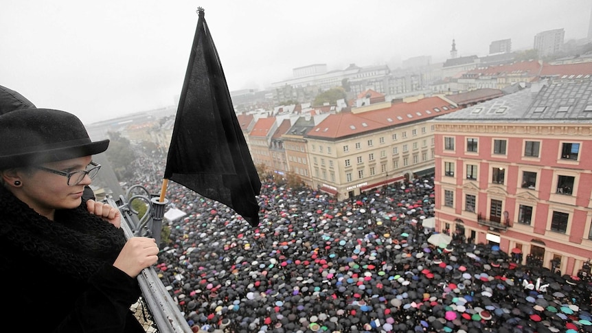 A woman observes thousands of people during an abortion rights campaigners' demonstration.