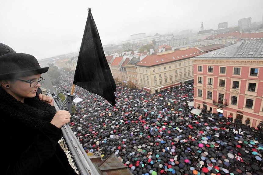 A woman observes thousands of people during an abortion rights campaigners' demonstration.