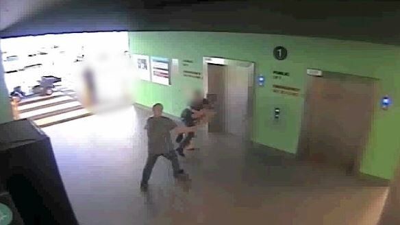 CCTV footage shows a patient at Logan Hospital being tackled by a security guard.