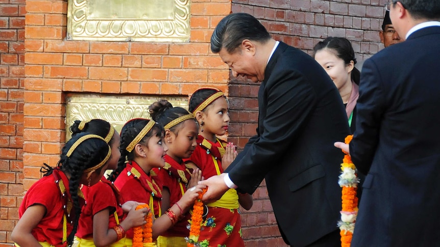 Chinese President Xi Jinping is greeted by Nepalese children upon arrival in Kathmandu