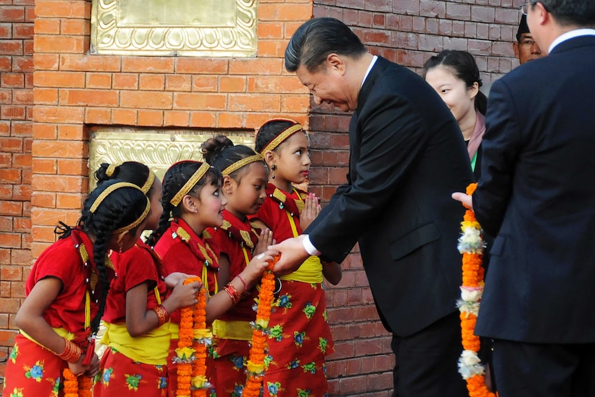 Chinese President Xi Jinping is greeted by Nepalese children upon arrival in Kathmandu