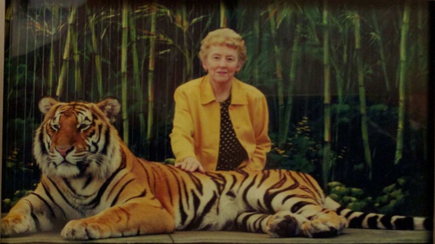 Richmond Tigers fan Peggy poses for a photograph with a live tiger.