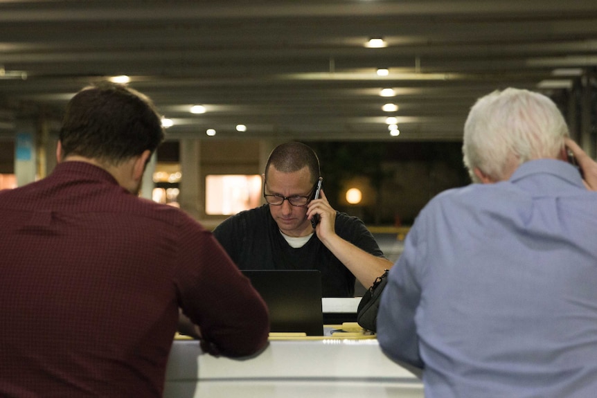 Capital Gazette colleagues in a parking garage of a mall in Annapolis