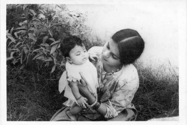 A black and white image of a mother holding her baby