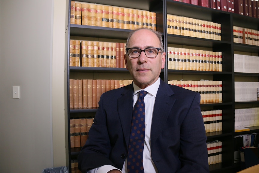 Lawyer Roland Browne in a library.