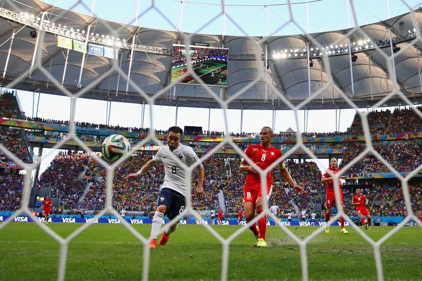 France's Mathieu Valbuena scores his team's third goal against Switzerland.