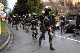 Members of the French National Police Intervention Groups (GIPN) walk through the village of Corcy (AFP: Francois lo Presti)