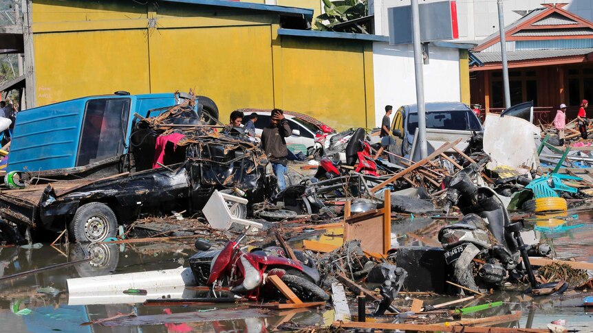 Cars and motorbikes amid the rubble in Indonesia