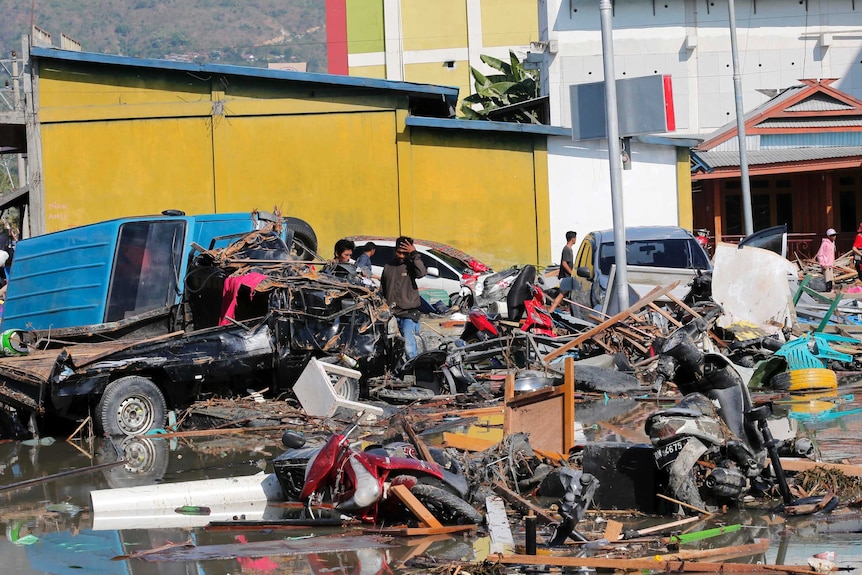 Cars and motorbikes amid the rubble in Indonesia