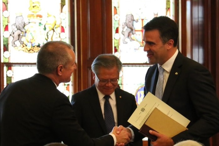 Premier Jay Weatherill shakes hand of new minister Peter Malinauskas.