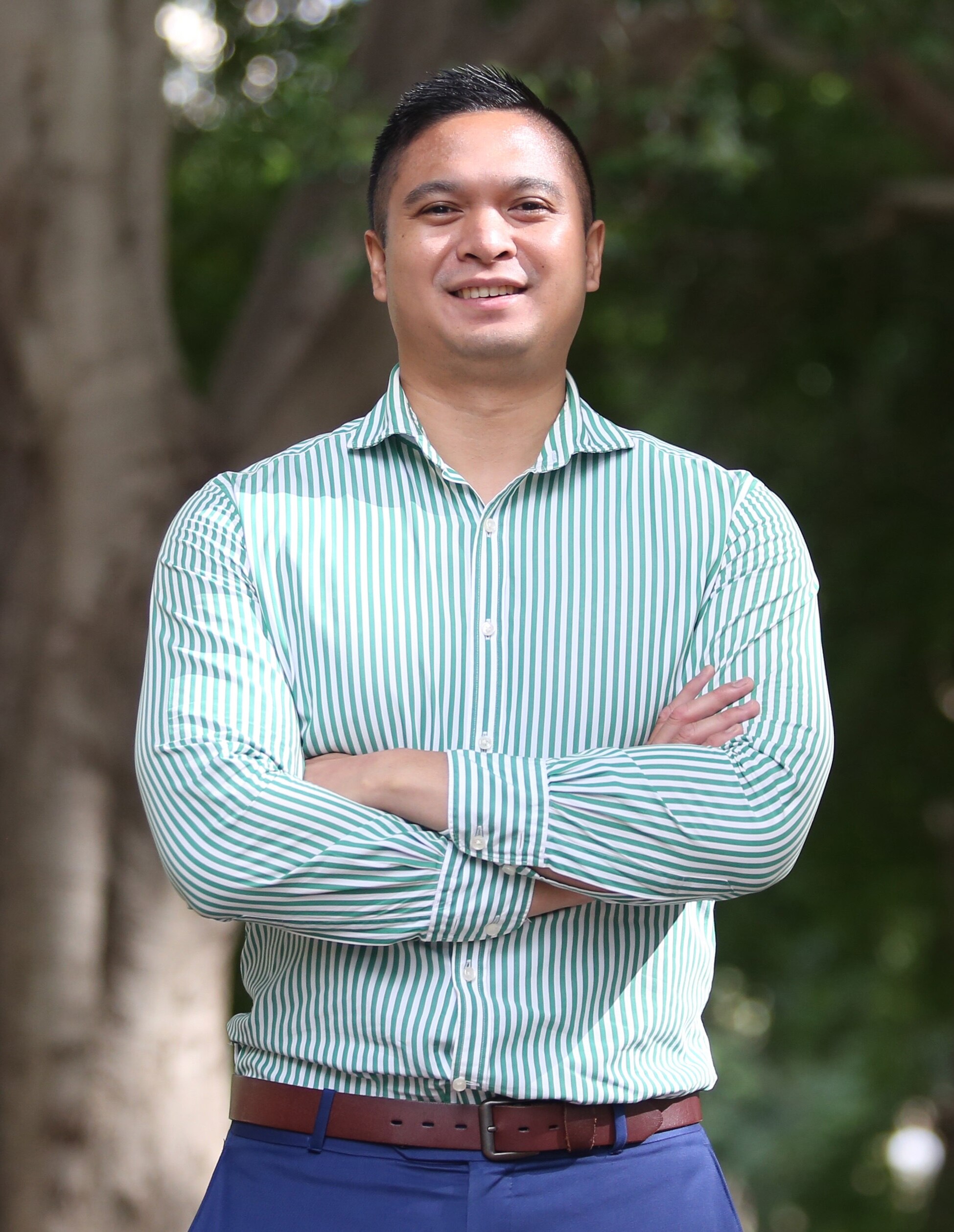 A man with arms crossed and smiling 