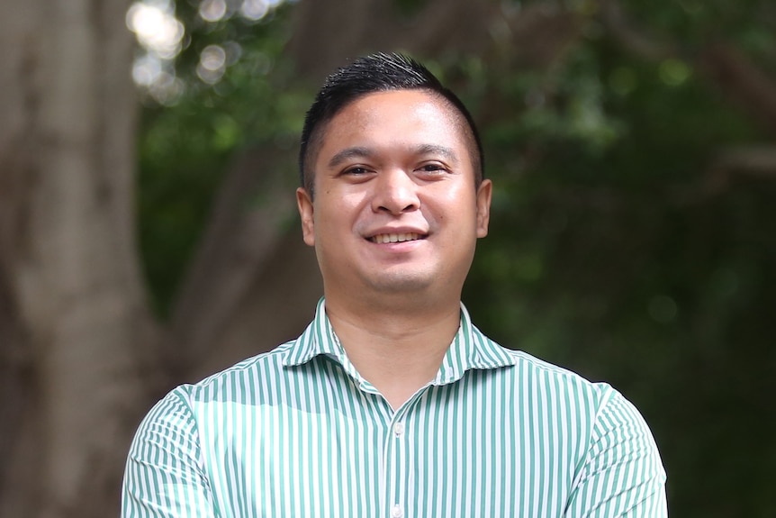 A man with arms crossed and smiling 