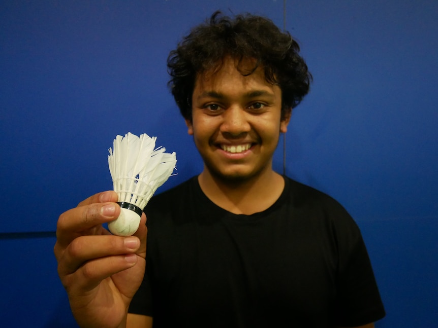 Rezwan holding up a shuttlecock.