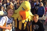 Hawks fans pose with Hawthorn mascot