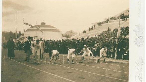 A black and white photo of men about to race at the Olympics in 1896