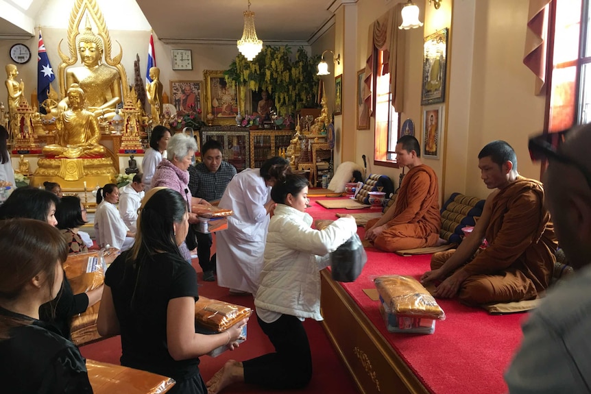 Thai Sydneysiders paying tribute to their deceased monarch at the Wat Buddharangsee Temple in Annandale.