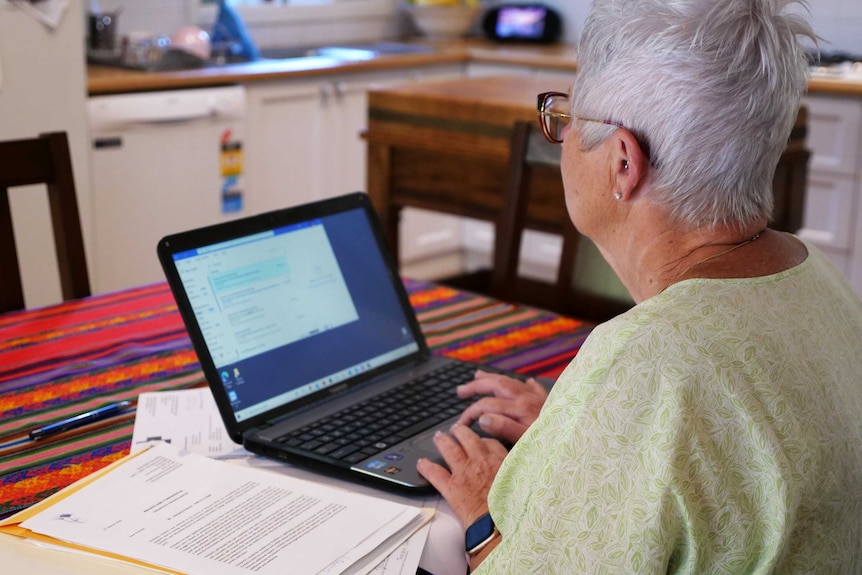 Therese works on her laptop.