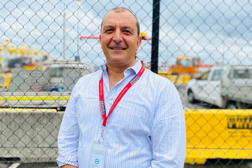 Patrick Terminals chief executive Michael Jovicic stands in front of a wire fence.