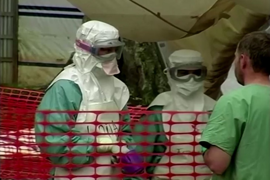 Medical workers dressed in protective gear.