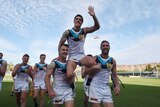 Power player Angus Monfries is held aloft by team-mates.