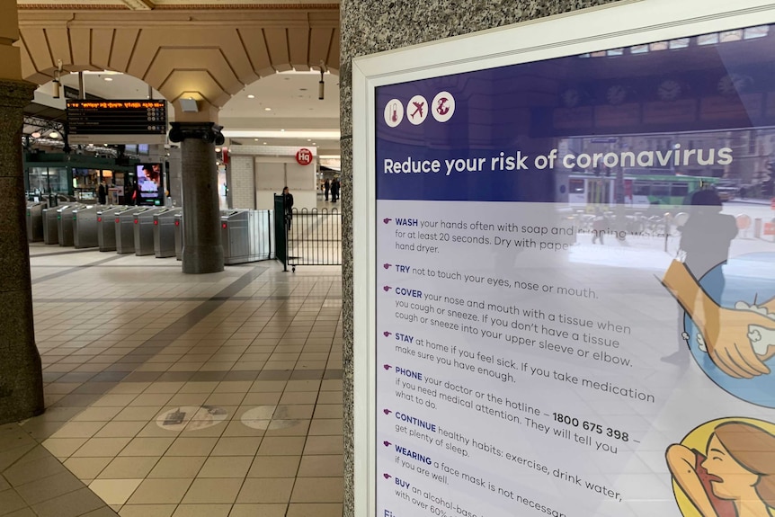 A coronavirus sign inside an empty Flinders St train station.