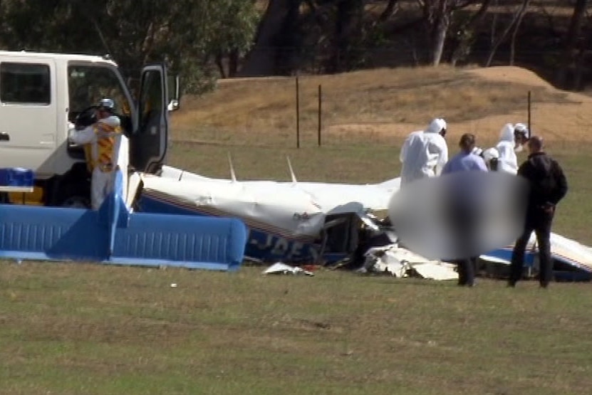 Forensic officers at the scene of a plane crash at Mangalore, Victoria.