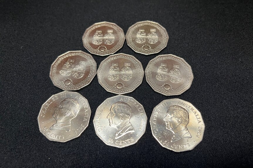 Specially designed silver 50 cent coins on a black table cloth