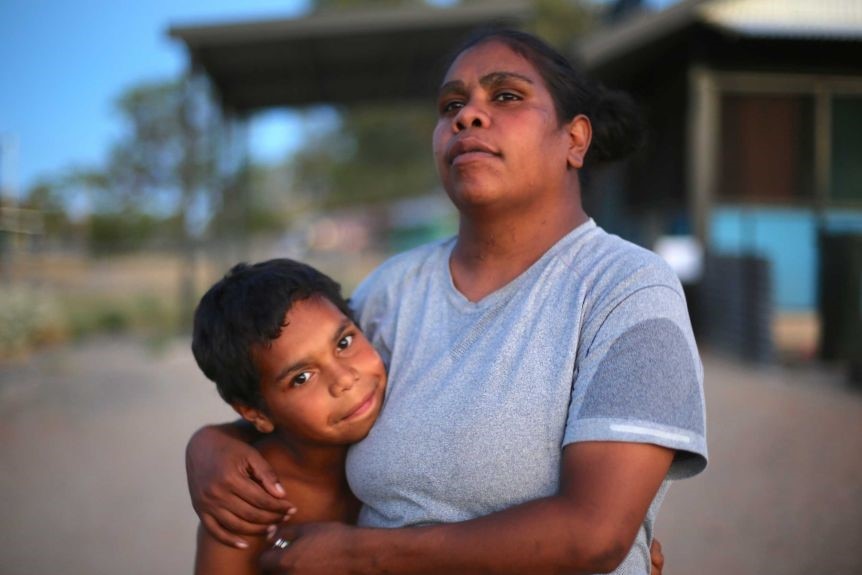 A woman hugs her child