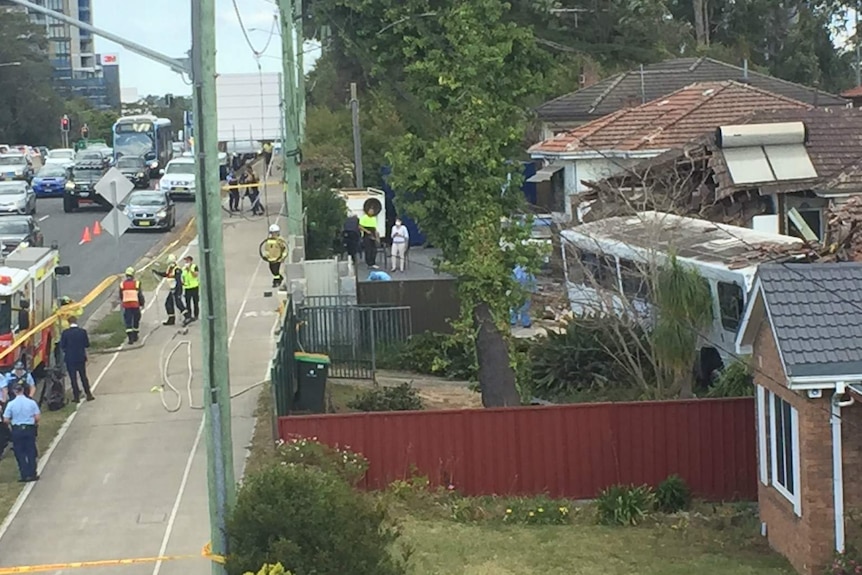 House wreckage and emergency services.