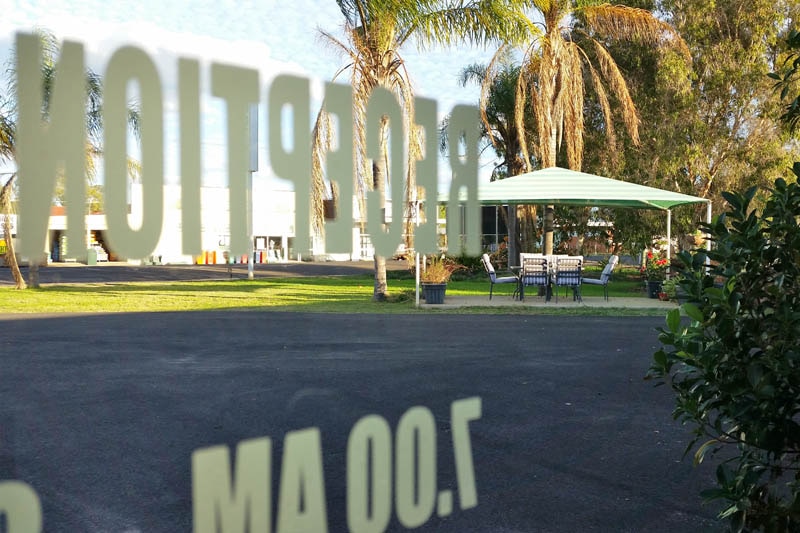 The door of the Waltzing Matilda Motor Inn in Charleville reflects an empty sitting area