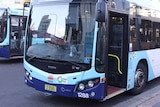 A NSW bus with its front door open.