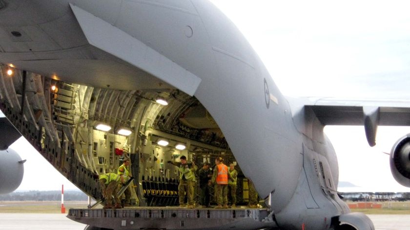 An RAAF C-17 is loaded with aid supplies