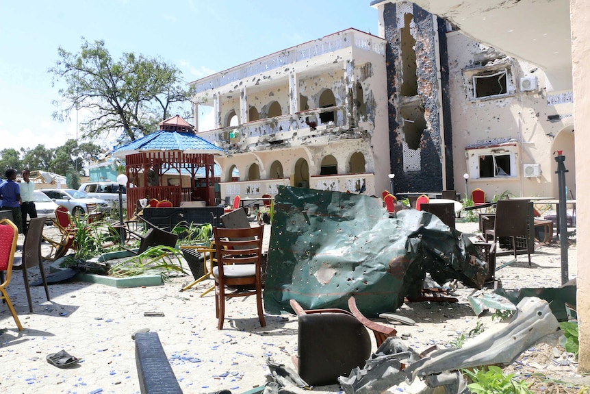 damaged artefacts outside of a hotel that has been face of  hotel that's been blown apart