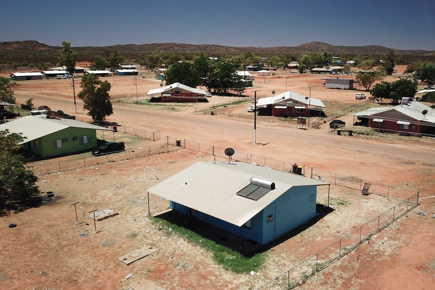 An aerial shot shows several small homes.