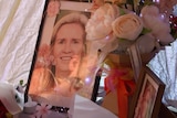 a table of photos of Samantha and flowers.
