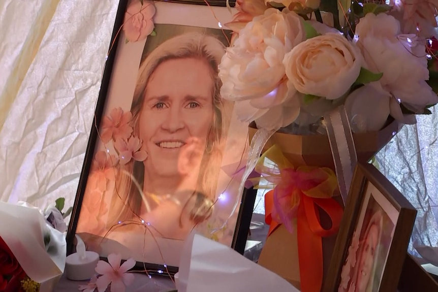 a table of photos of Samantha and flowers.