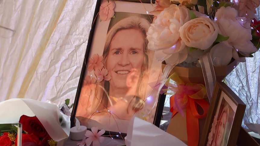 a table of photos of Samantha and flowers.