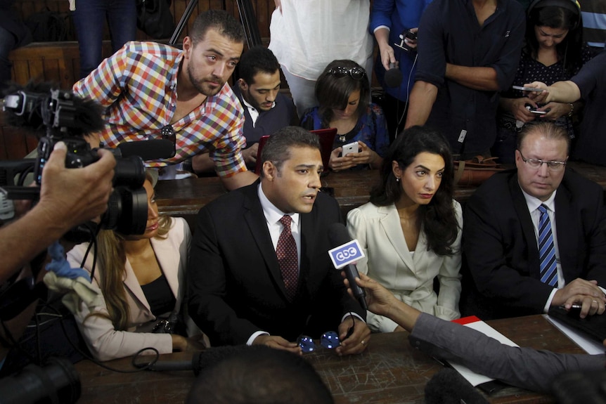 Al Jazeera television journalists talk to the media