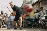 Steve Waugh plays cricket in a street in India.