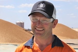 GrainCorp manager Brad Foster stands in front of a pile of chickpeas at the new grain facility at the CQ Inland Port