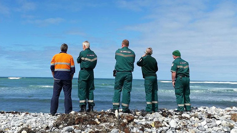 Crews survey the sea after a boat capsized off Cape Douglas
